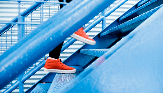 Image of man walking up the stairs. 