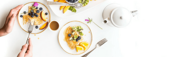 image of someone eating off of a small plate as a healthy hack